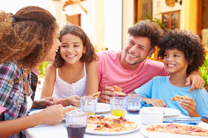 Family gathered at an outdoor restaurant to share a meal