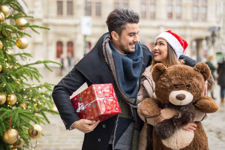 Happy couple shopping for christmas