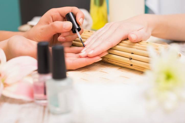 Nail technician giving customer a manicure Nail technician giving customer a manicure